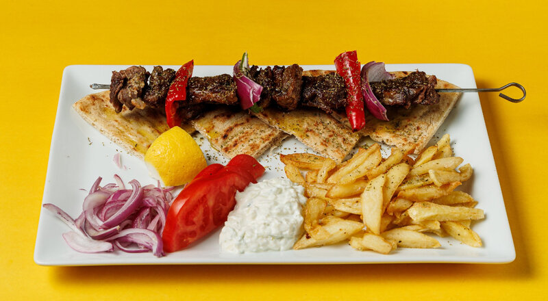 GRILLED LAMB SOUVLAKI,TOMATO,ONION,TZATZIKI,PITA,FRENCH POTATOES
